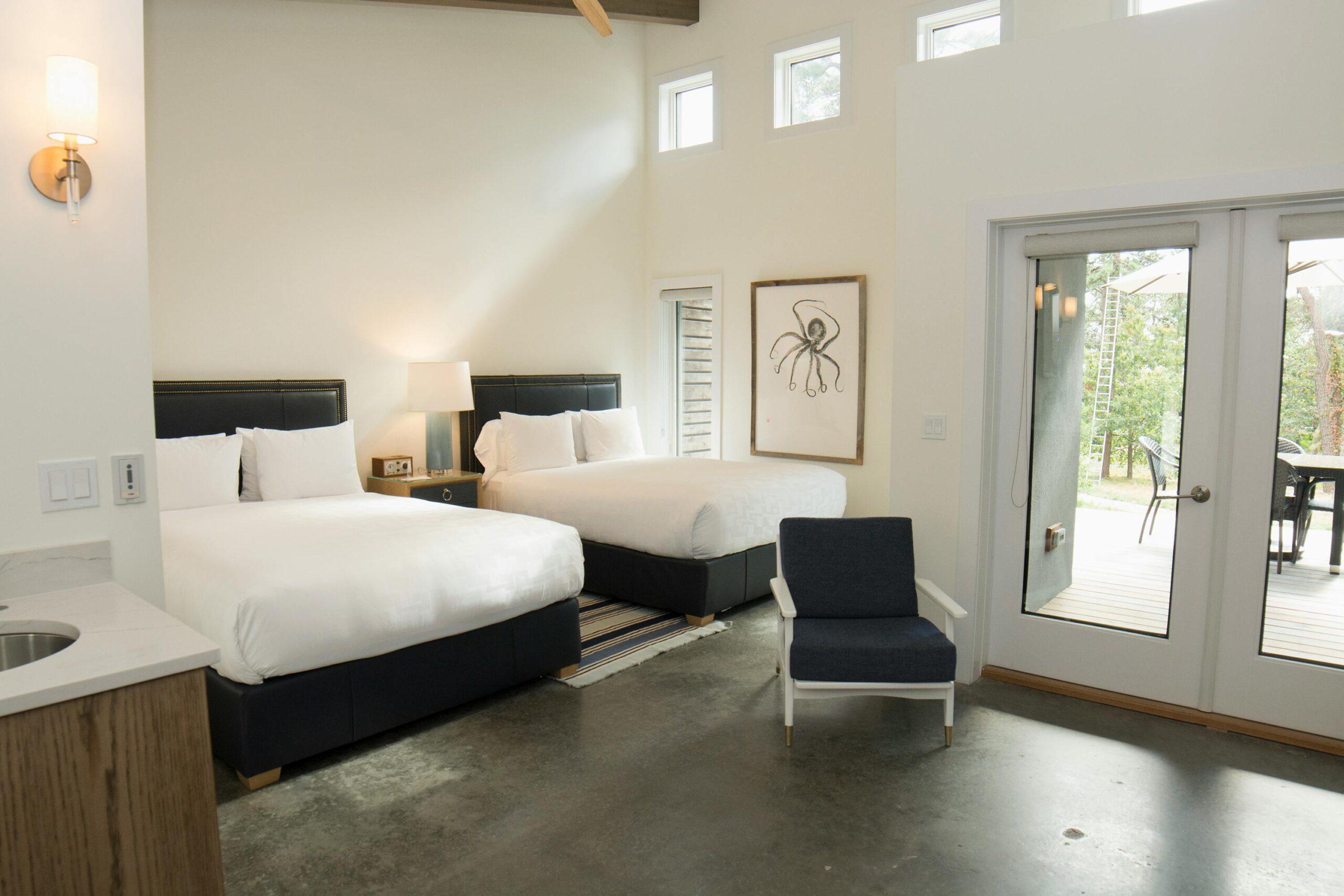 Inviting bedroom with twin beds and contemporary design in Hampton Bays, New York.
