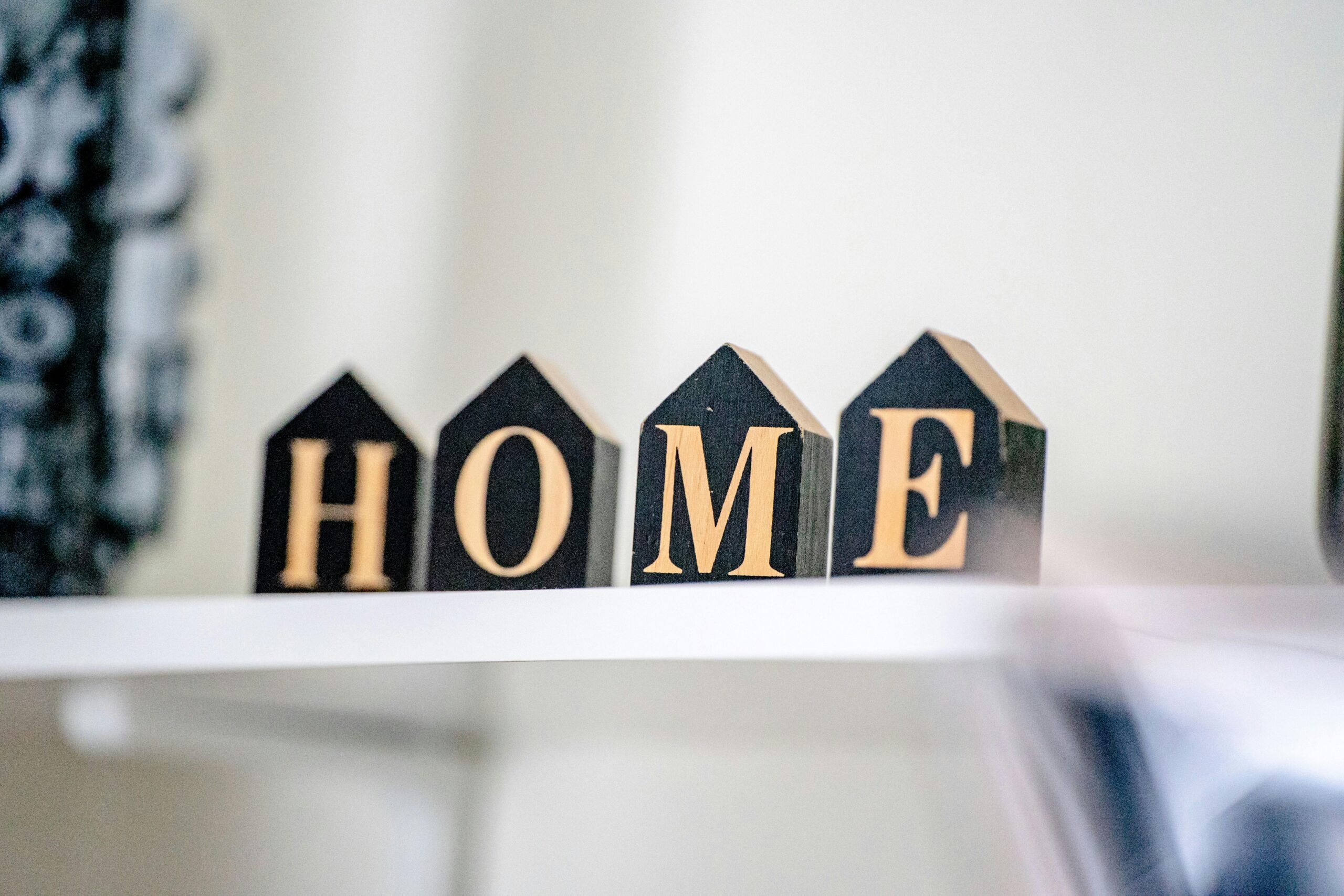 Stylish wooden block letters spelling "HOME" for cozy home decor.